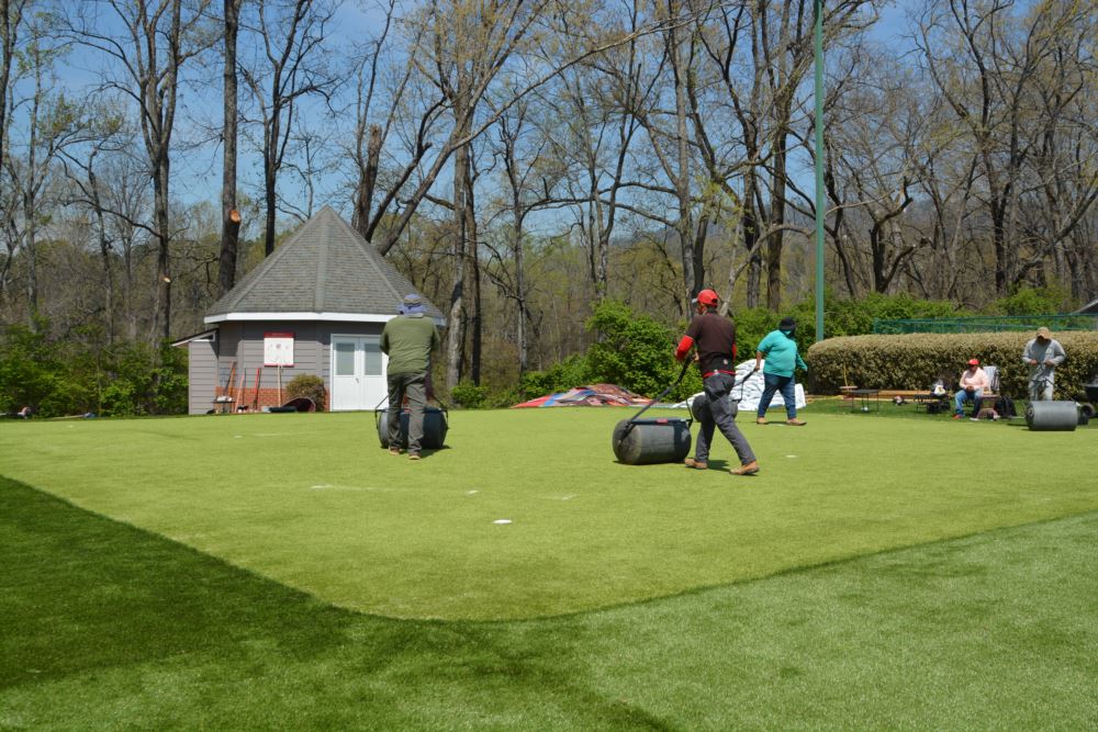 install crew working on artificial grass
