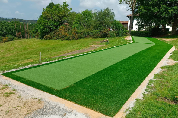 Atlanta Outdoor tee line consisting of one continuous green synthetic grass strip surrounded by trees